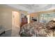 Comfortable bedroom featuring a ceiling fan and a view into the backyard at 2360 Unity Ter, The Villages, FL 32162