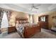 Serene main bedroom with tray ceiling, ceiling fan, and coordinating furniture at 2360 Unity Ter, The Villages, FL 32162