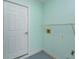 Laundry room featuring a utility sink, door, shelf, and electrical outlets at 26315 Newcombe Cir, Leesburg, FL 34748