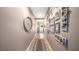 A welcoming hallway featuring neutral paint, decorative wall art, and tile flooring that leads to the home's entrance at 26747 White Plains Way, Leesburg, FL 34748