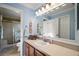 Bathroom featuring blue walls, framed mirror over vanity, and shower with glass doors at 273 Pomaria Pl, The Villages, FL 32162