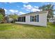 A sunroom addition with lots of windows brightens this home's screened lanai and back yard at 273 Pomaria Pl, The Villages, FL 32162