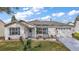 Charming single-story home featuring a well-manicured lawn and inviting curb appeal with a white picket fence at 273 Pomaria Pl, The Villages, FL 32162