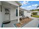 Inviting front entrance with a decorative door, blue shutters, and a cozy bench, creating a welcoming ambiance at 273 Pomaria Pl, The Villages, FL 32162