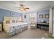 Spacious main bedroom with blue walls, carpet, white trim, and a decorative ceiling fan at 273 Pomaria Pl, The Villages, FL 32162