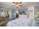 Light-filled main bedroom features calming paint, ceiling fan, and an en suite bath at 273 Pomaria Pl, The Villages, FL 32162