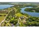 Breathtaking aerial view of a lakefront community with luxury homes surrounded by lush greenery and waterways at 27852 Lake Jem Rd, Mount Dora, FL 32757