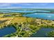 Wide aerial shot of a vast lakefront property, showing the home's location within a beautiful natural landscape at 27852 Lake Jem Rd, Mount Dora, FL 32757