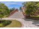 Stone stairs and landscaped walkway lead to this stunning estate home at 27852 Lake Jem Rd, Mount Dora, FL 32757