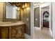 The bathroom has a decorative vanity, ornate mirror, and an open doorway into a bedroom at 27852 Lake Jem Rd, Mount Dora, FL 32757