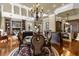 Cozy dining area featuring elegant chandelier, hardwood floors, and access to additional living spaces at 27852 Lake Jem Rd, Mount Dora, FL 32757