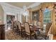 Formal dining room with chandelier, custom drapes, and hardwood flooring at 27852 Lake Jem Rd, Mount Dora, FL 32757