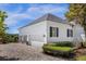 Three-car garage featuring white siding and a brick-paved driveway at 27852 Lake Jem Rd, Mount Dora, FL 32757