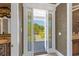 A hallway looking out to a patio area with decorative stained glass windows flanking an open doorway at 27852 Lake Jem Rd, Mount Dora, FL 32757