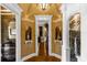 Elegant hallway with hardwood floors, decorative niches, and sophisticated lighting at 27852 Lake Jem Rd, Mount Dora, FL 32757