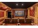 Luxurious home theater with comfortable seating, a large screen, and detailed woodwork for an immersive experience at 27852 Lake Jem Rd, Mount Dora, FL 32757