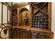 Detailed wine cellar with custom wood shelving and elegant decor for storing and displaying wine bottles at 27852 Lake Jem Rd, Mount Dora, FL 32757