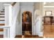 Staircase leading to a unique wine cellar behind ornate wrought-iron gates, adding charm to the space at 27852 Lake Jem Rd, Mount Dora, FL 32757