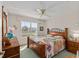 Bedroom features a ceiling fan, window, and dresser at 3009 Batally Ct, The Villages, FL 32162