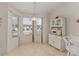 Sunny breakfast nook with bay windows and built-in cabinet at 3009 Batally Ct, The Villages, FL 32162