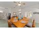 View of the dining room featuring an inviting wooden table, set with placemats and blue glass centerpieces at 3009 Batally Ct, The Villages, FL 32162