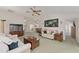 Bright living room with ceiling fan, two couches and a large painting of a frog on the wall at 3009 Batally Ct, The Villages, FL 32162