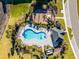 Aerial of the community pool, cabana, and playground with the homes surrounded by sidewalks at 3009 High Pointe St, Clermont, FL 34711