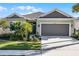 Charming single-story home featuring a well-manicured lawn and a two-car garage at 3009 High Pointe St, Clermont, FL 34711