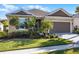 Charming single-story home featuring a well-manicured lawn and a two-car garage at 3009 High Pointe St, Clermont, FL 34711