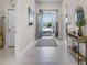 Bright foyer featuring tile flooring, stylish decor, and a welcoming open doorway at 3009 High Pointe St, Clermont, FL 34711