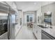 Bright kitchen with stainless steel appliances, white cabinets, and a view of the dining area at 3009 High Pointe St, Clermont, FL 34711