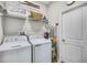 Well-equipped laundry room features a washer, dryer, and ample storage for convenience at 3009 High Pointe St, Clermont, FL 34711