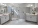 Modern bathroom with double vanities, a glass-enclosed shower, and ample natural light at 3009 High Pointe St, Clermont, FL 34711