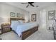 Well-lit main bedroom with a dark wood bed frame and a neutral color palette at 3009 High Pointe St, Clermont, FL 34711