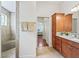 Bathroom featuring a tiled shower and wood cabinet with granite countertop at 3047 Bevill Ln, The Villages, FL 32163