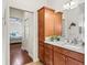 Bathroom featuring wood cabinet with granite countertop and tile flooring at 3047 Bevill Ln, The Villages, FL 32163