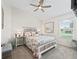 Cozy bedroom with a queen-size bed, ceiling fan, and a window at 3047 Bevill Ln, The Villages, FL 32163