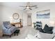 Bright living room with an armchair, a sofa, and a ceiling fan at 3047 Bevill Ln, The Villages, FL 32163