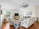 Living room featuring hardwood floors, a ceiling fan, and an abundance of natural light at 3047 Bevill Ln, The Villages, FL 32163