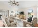 Living room with hardwood floors, ceiling fan, and an abundance of natural light at 3047 Bevill Ln, The Villages, FL 32163