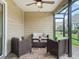 Screened outdoor patio with comfortable seating for relaxing and enjoying the outdoor view at 3047 Bevill Ln, The Villages, FL 32163