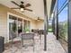 Comfortable screened patio for outdoor dining featuring brick flooring, ceiling fans, and ample space at 3047 Bevill Ln, The Villages, FL 32163