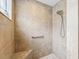 Tiled walk-in shower featuring a built-in bench and a handheld shower head at 3047 Bevill Ln, The Villages, FL 32163