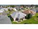 Overhead view of a house with a gray roof, green grass, and a sunroom at 3056 Saint Thomas Ln, The Villages, FL 32162