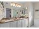 Well-lit bathroom with a double sink vanity and shower at 3056 Saint Thomas Ln, The Villages, FL 32162