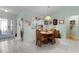 Charming dining area adjacent to the entry with a view of the kitchen at 3056 Saint Thomas Ln, The Villages, FL 32162