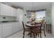 Cozy breakfast nook bathed in natural light with crisp white cabinets for storage at 3056 Saint Thomas Ln, The Villages, FL 32162