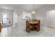 Dining room with wood table, chairs, and a view into the kitchen through a pass-through window at 3056 Saint Thomas Ln, The Villages, FL 32162