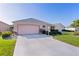 Well-kept one-story home with a neat driveway and manicured front yard at 3056 Saint Thomas Ln, The Villages, FL 32162