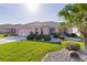 Well-manicured front yard with lush green grass and mature landscaping around charming home at 3056 Saint Thomas Ln, The Villages, FL 32162